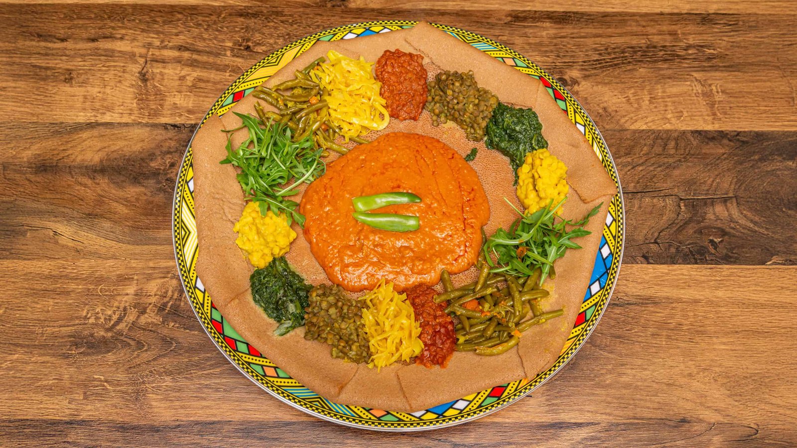 Plant-based Eritrean and Ethiopian beyaynetu platter on injera
