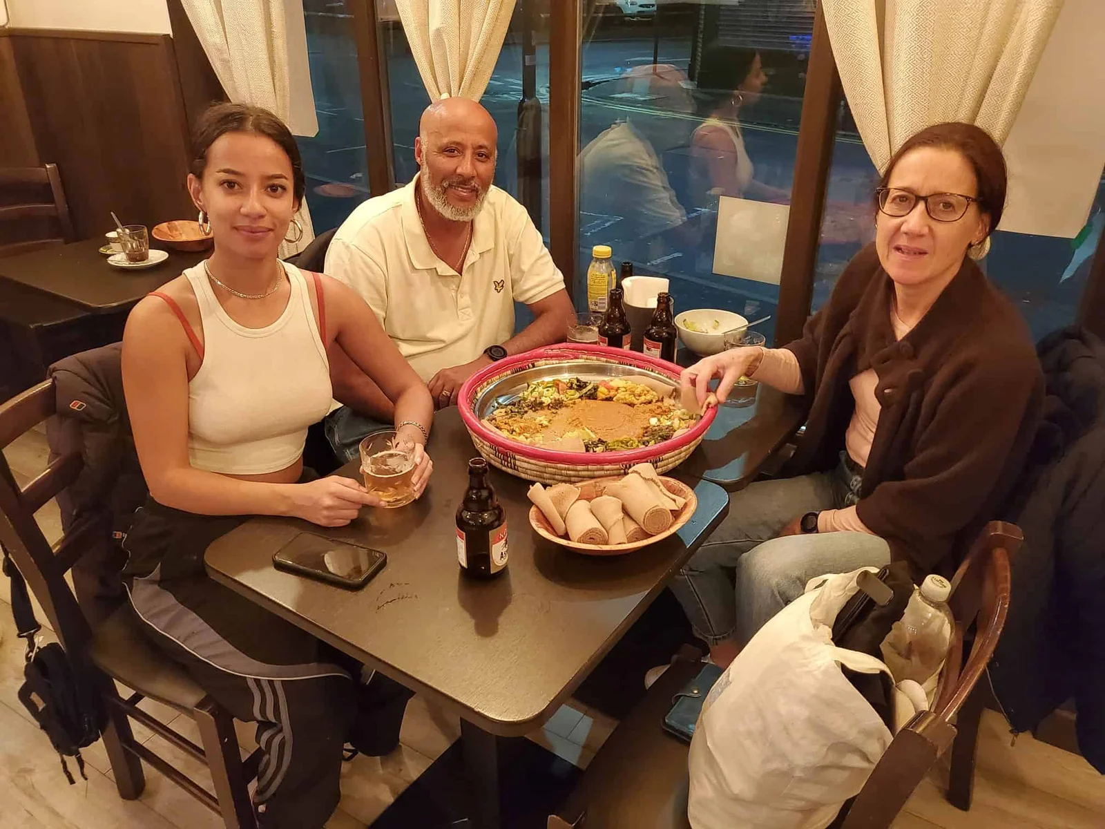A family sharing injera together at Asmara Bella